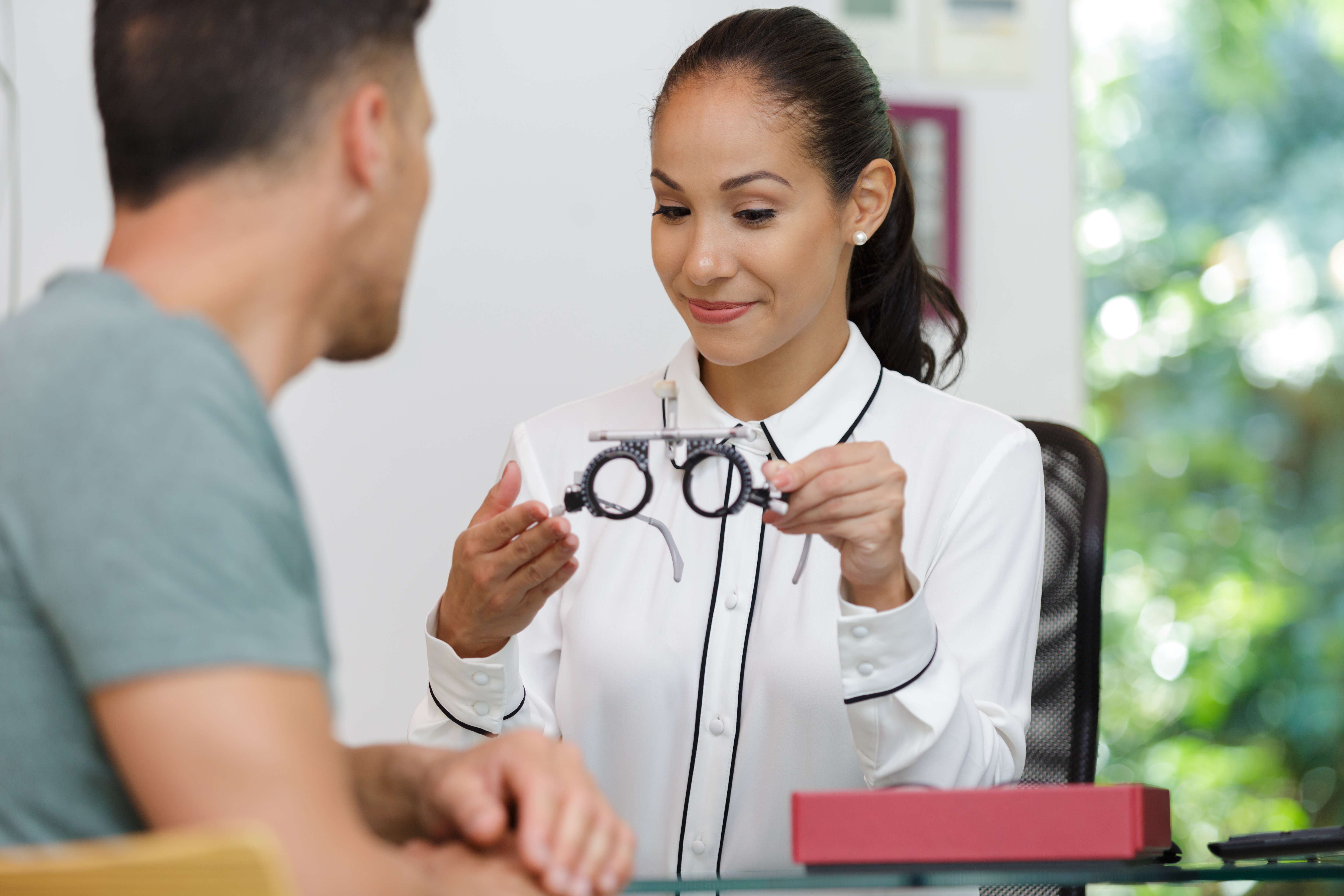 Pretty young woman cotor during eye test