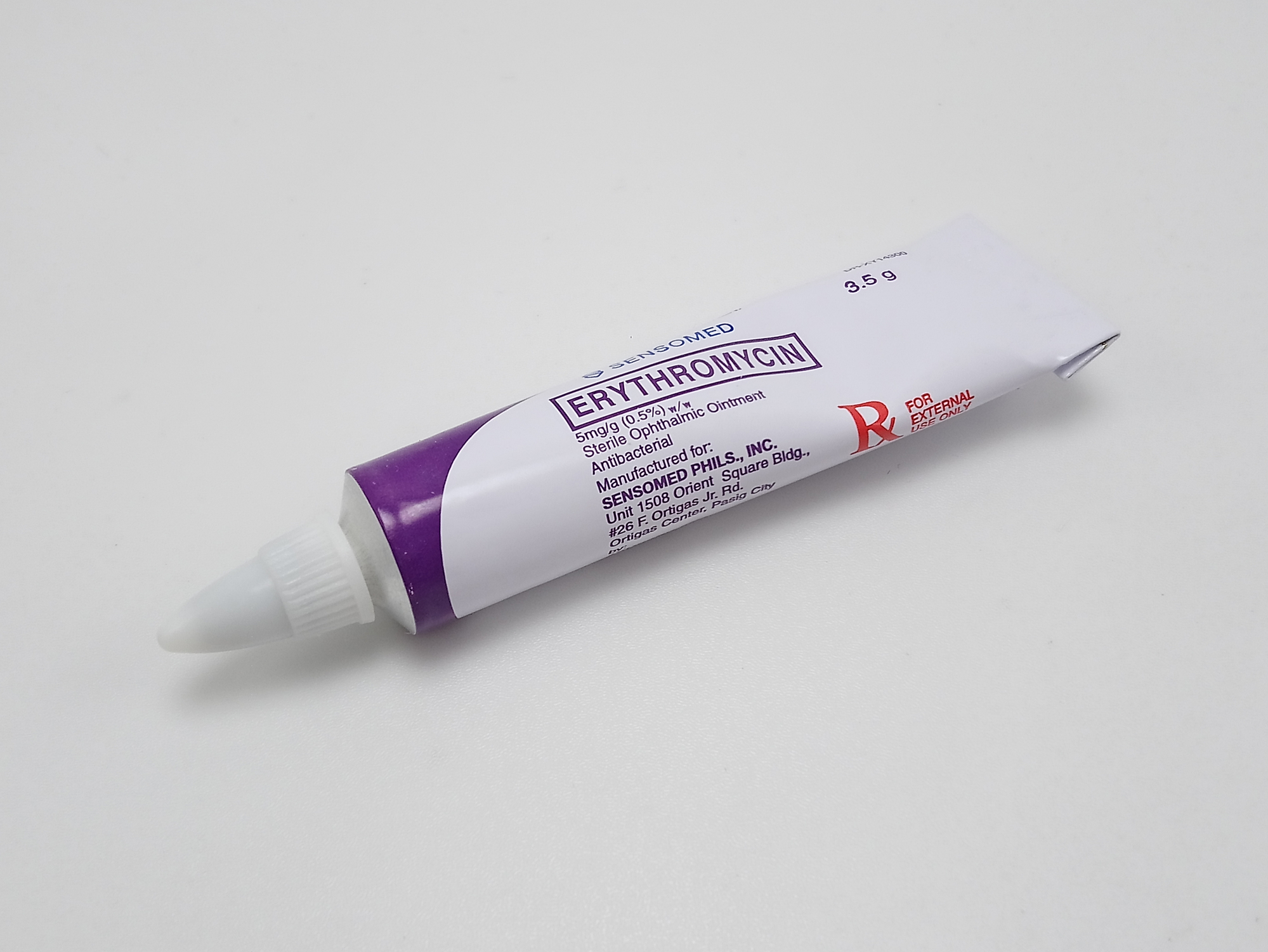 Erythromycin eye ointment in tube pictured on white table background